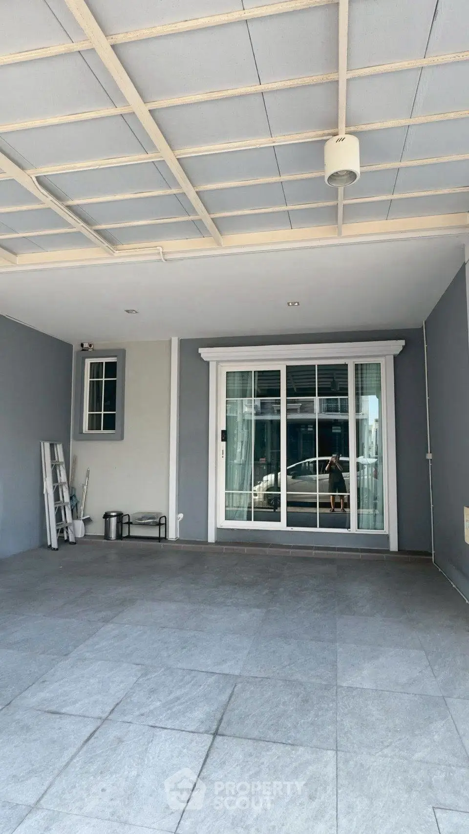 Spacious covered patio with sliding glass doors and modern design.