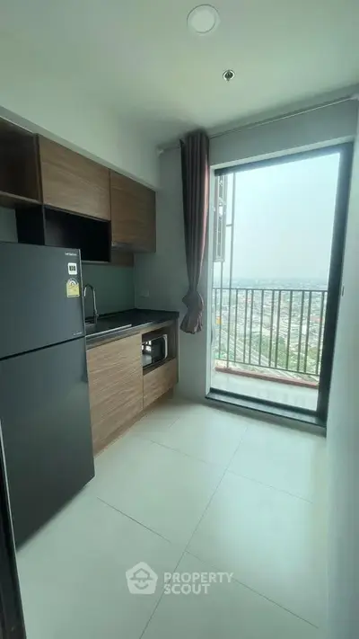 Modern kitchen with balcony view in high-rise apartment