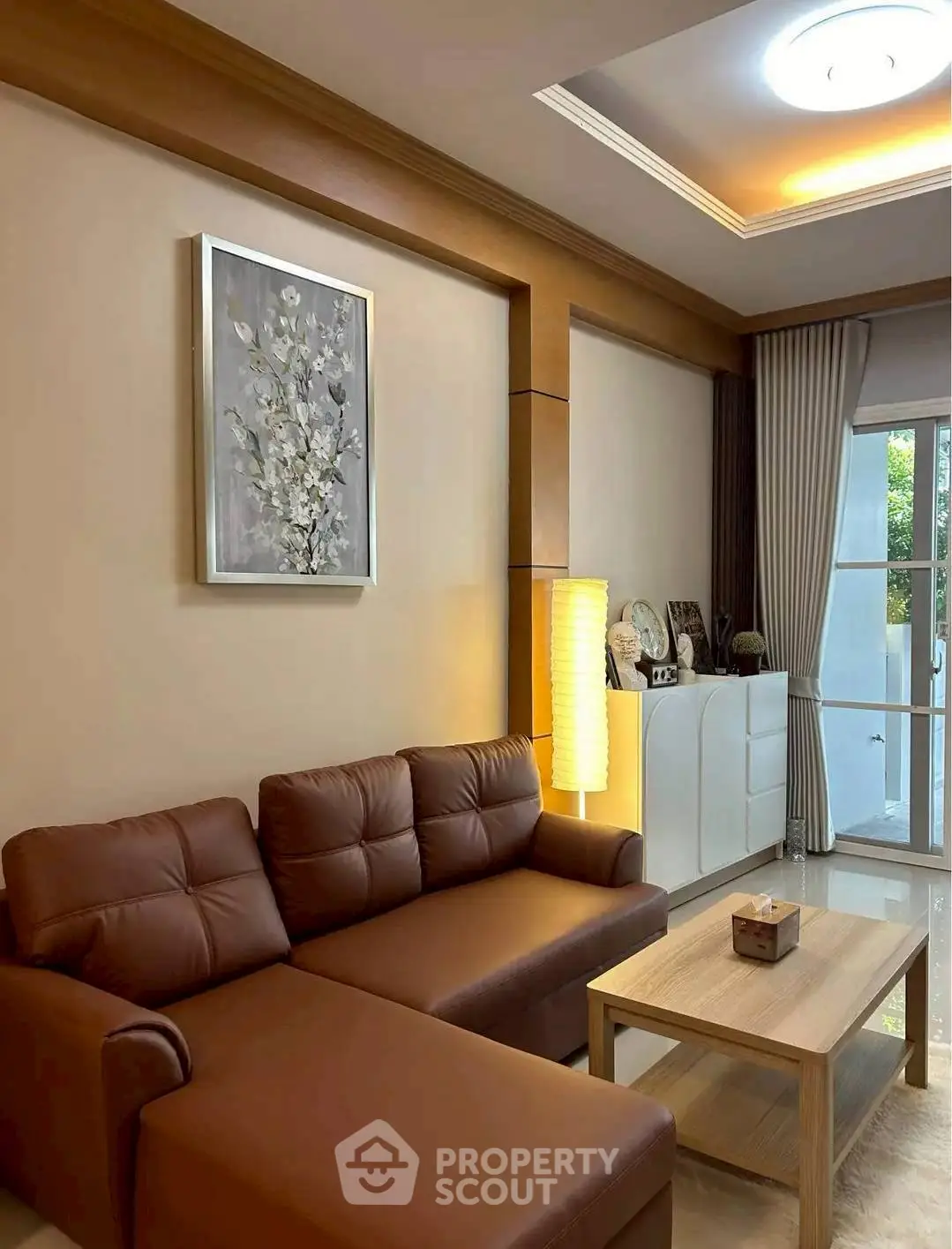 Stylish living room with brown leather sofa and modern decor