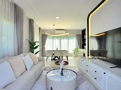 Modern living room with elegant decor and large windows