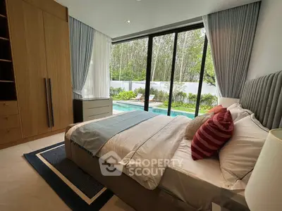 Luxurious bedroom with pool view, featuring modern decor and large glass doors opening to a serene garden.