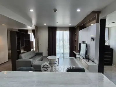 Modern living room with sleek design and large windows for natural light.