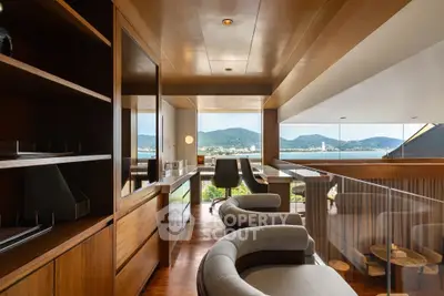 Luxurious study room with stunning mountain and sea view, featuring elegant wooden decor and modern furniture.