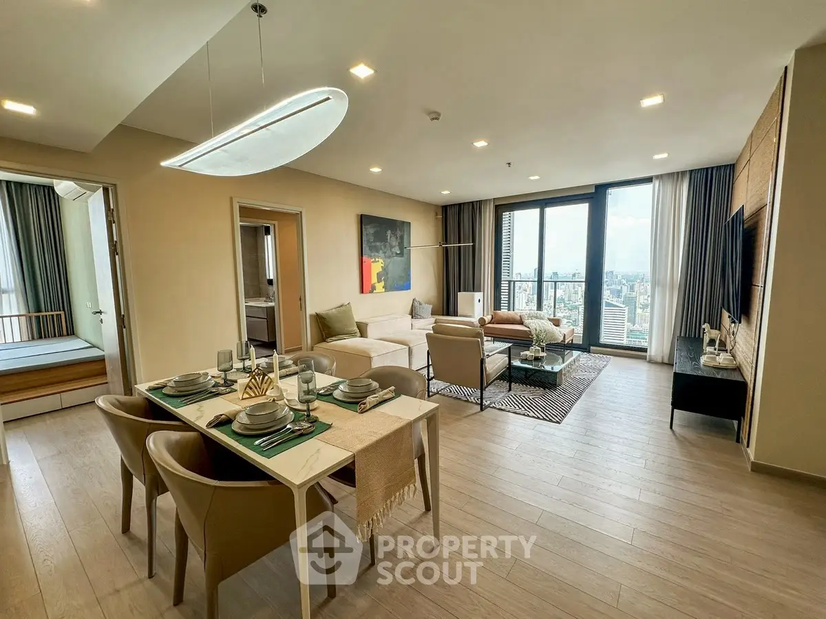 Spacious modern living room with dining area and city view balcony in luxury apartment.