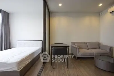 Modern studio apartment with cozy living area and stylish furniture