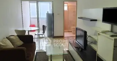 Cozy living room with modern furniture and balcony access in urban apartment.