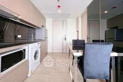 Modern kitchen with sleek dining area and built-in appliances