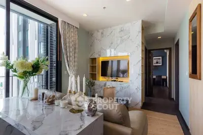 Luxurious modern living room with marble accents and city view balcony.