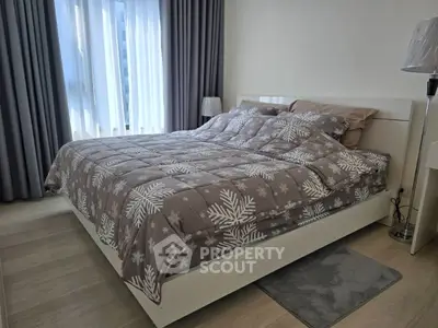 Cozy bedroom with modern decor and large window for natural light