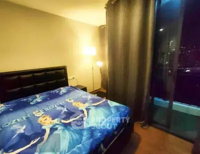 Cozy bedroom with Frozen-themed bedding and city view from window.
