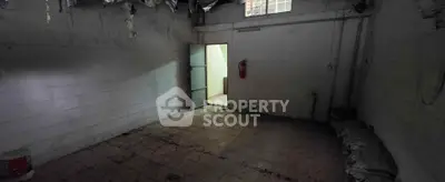 Spacious basement storage area with potential for renovation and ample lighting.