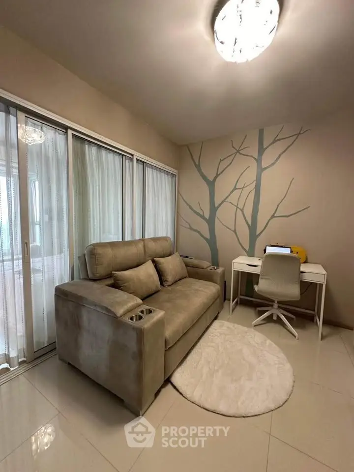 Cozy living room with modern sofa and study desk, featuring a unique wall design and natural light.