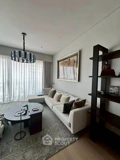 Elegant living room with modern decor and large window for natural light