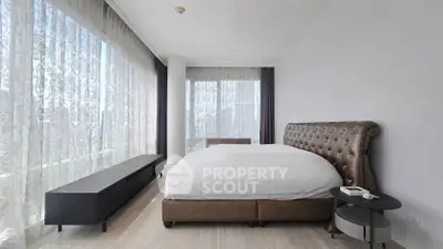 Luxurious bedroom with floor-to-ceiling windows and elegant furnishings