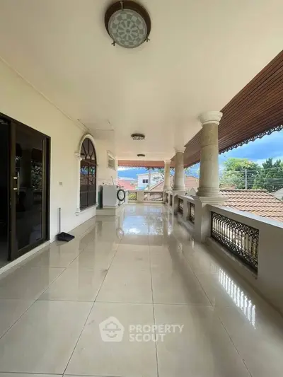 Spacious balcony with tiled flooring and scenic view, perfect for relaxation.