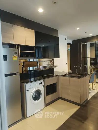 Modern kitchen with sleek cabinetry, built-in appliances, and stylish design in a contemporary apartment.