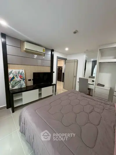 Modern bedroom with sleek design, featuring a cozy bed, stylish TV unit, and elegant decor.