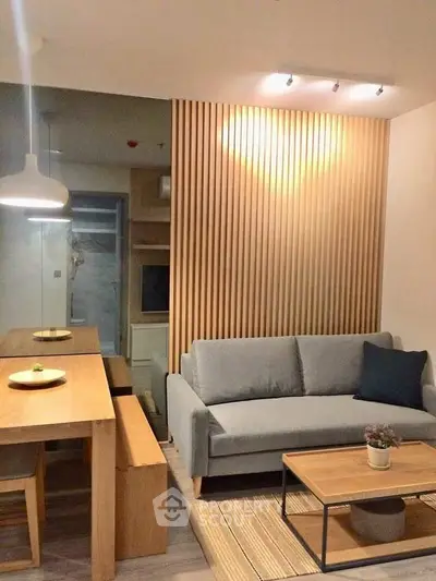 Modern living room with stylish wooden paneling and cozy gray sofa