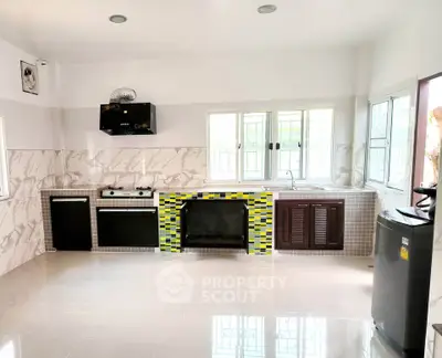 Modern kitchen with colorful backsplash and sleek appliances