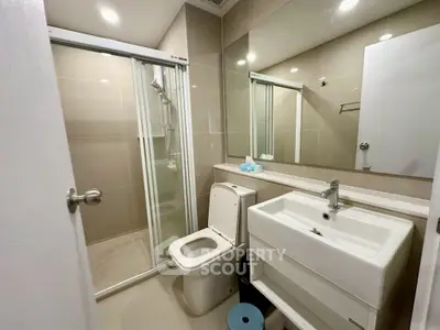 Modern bathroom with sleek fixtures and glass shower enclosure
