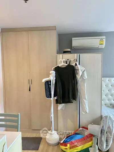 Cozy bedroom with modern wardrobe and air conditioning, perfect for comfortable living.