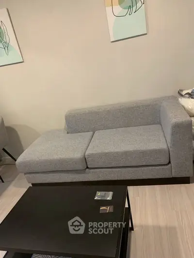 Modern living room with stylish gray sofa and sleek black coffee table, perfect for contemporary interiors.