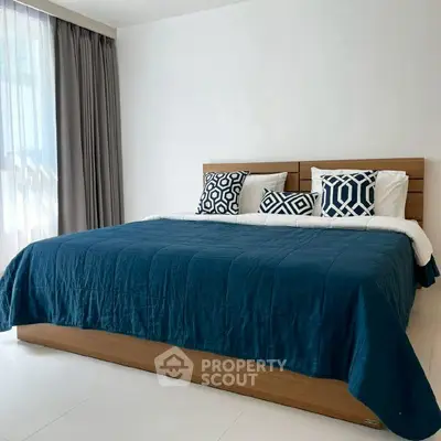 Spacious bedroom with modern decor and large bed in a bright apartment.