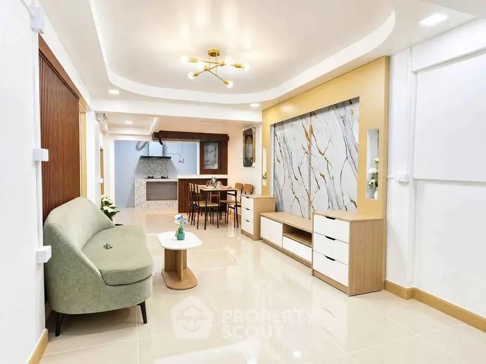 Modern open-plan living room with stylish furniture and elegant marble accent wall