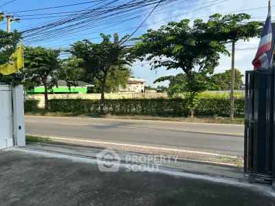 Charming suburban street view with lush greenery and clear skies, perfect for peaceful living.