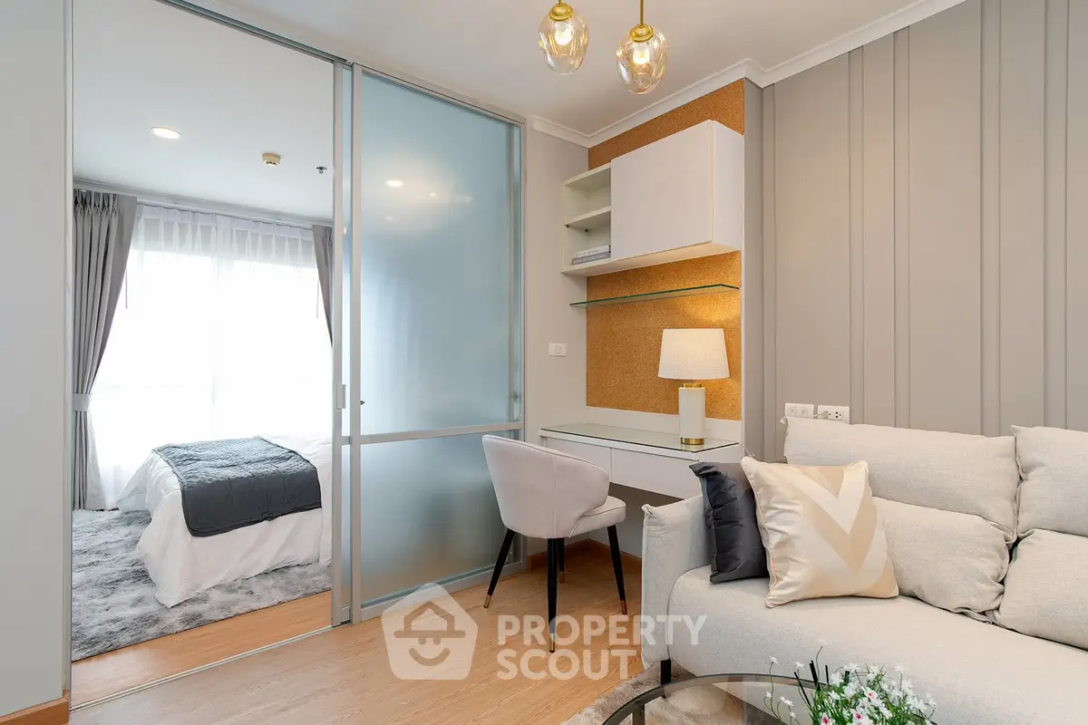 Modern living room with cozy bedroom view, featuring elegant decor and natural light.