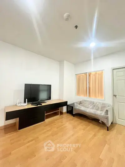 Spacious living room with modern TV setup and cozy seating area