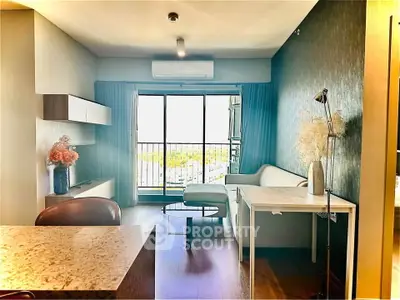 Modern living room with balcony view, stylish decor, and natural light.