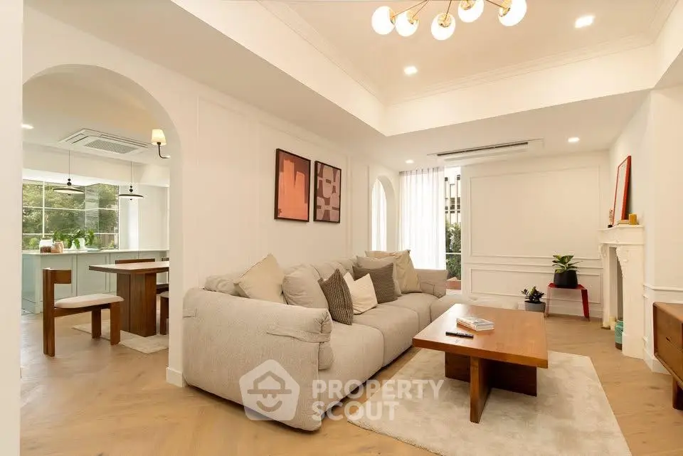 Spacious living room with modern decor and open kitchen layout