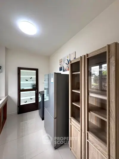 Modern kitchen with sleek appliances and ample storage in a bright, airy space.
