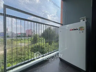 Modern balcony with scenic view and washing machine, perfect for urban living.