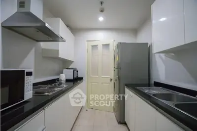Modern kitchen with sleek white cabinets and stainless steel appliances