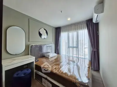 Modern bedroom with large window and city view, featuring stylish decor and air conditioning.