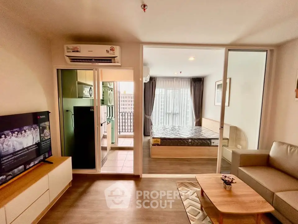 Modern studio apartment with open layout, featuring a cozy living area, compact kitchen, and inviting bedroom.