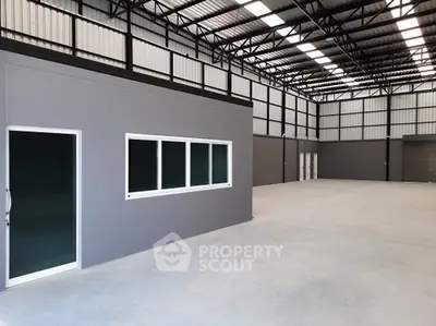 Spacious industrial warehouse with modern design and ample natural light.