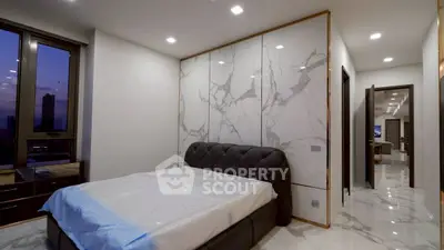 Luxurious modern bedroom with marble accents and city view