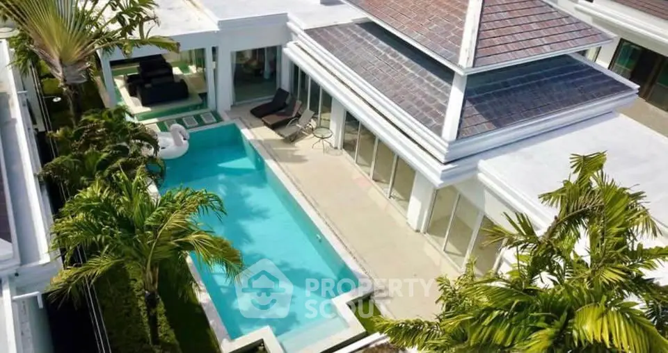 Luxurious villa with private pool and lush garden, perfect for tropical living.