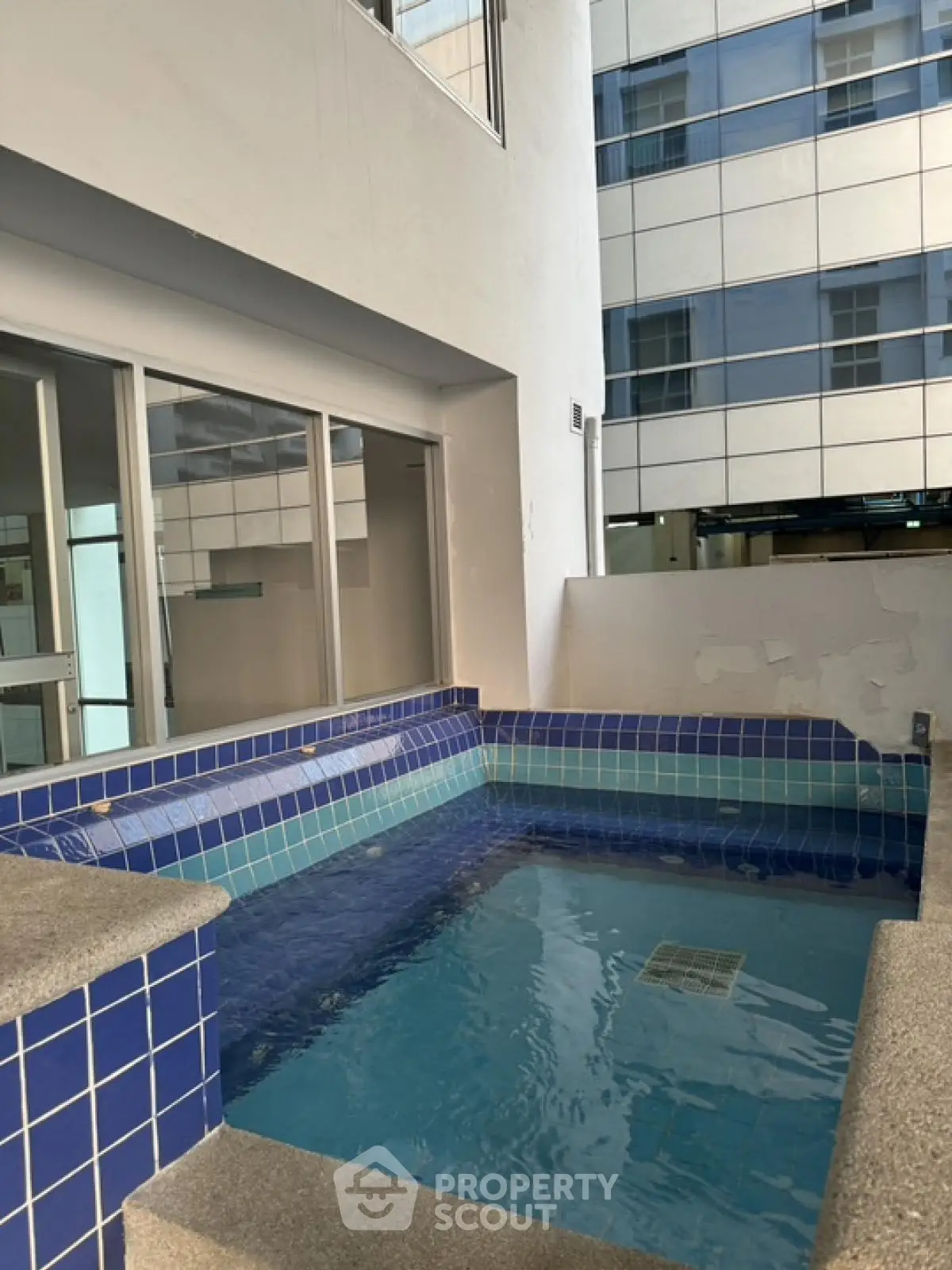 Modern apartment complex with private pool and sleek architectural design