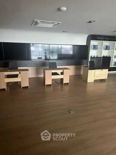 Spacious modern office space with sleek wooden flooring and minimalist design