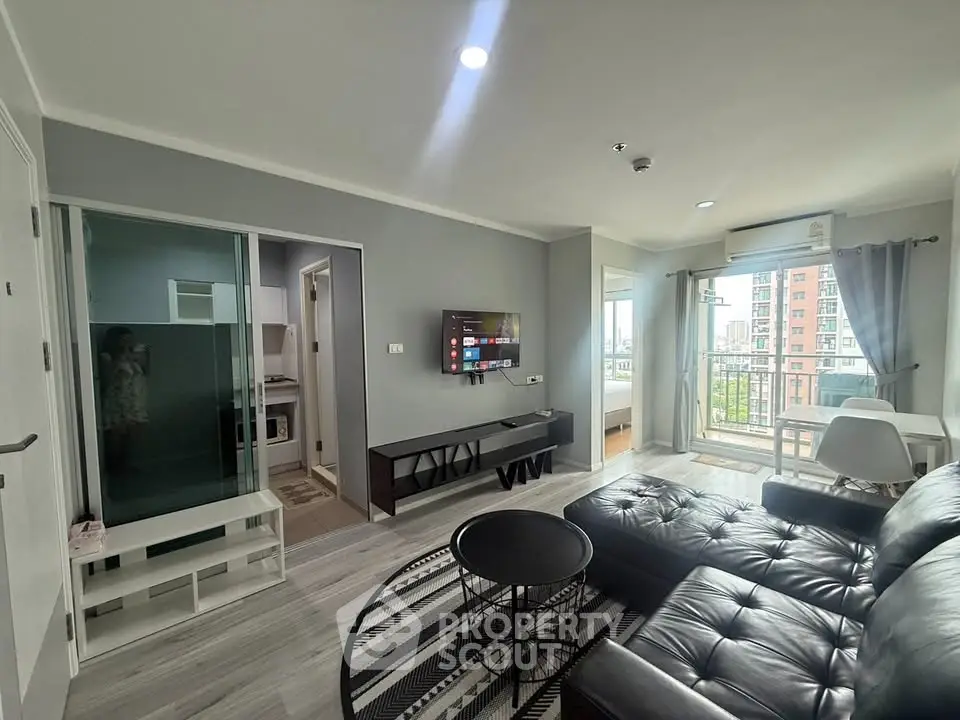 Modern living room with sleek furniture and balcony view in urban apartment