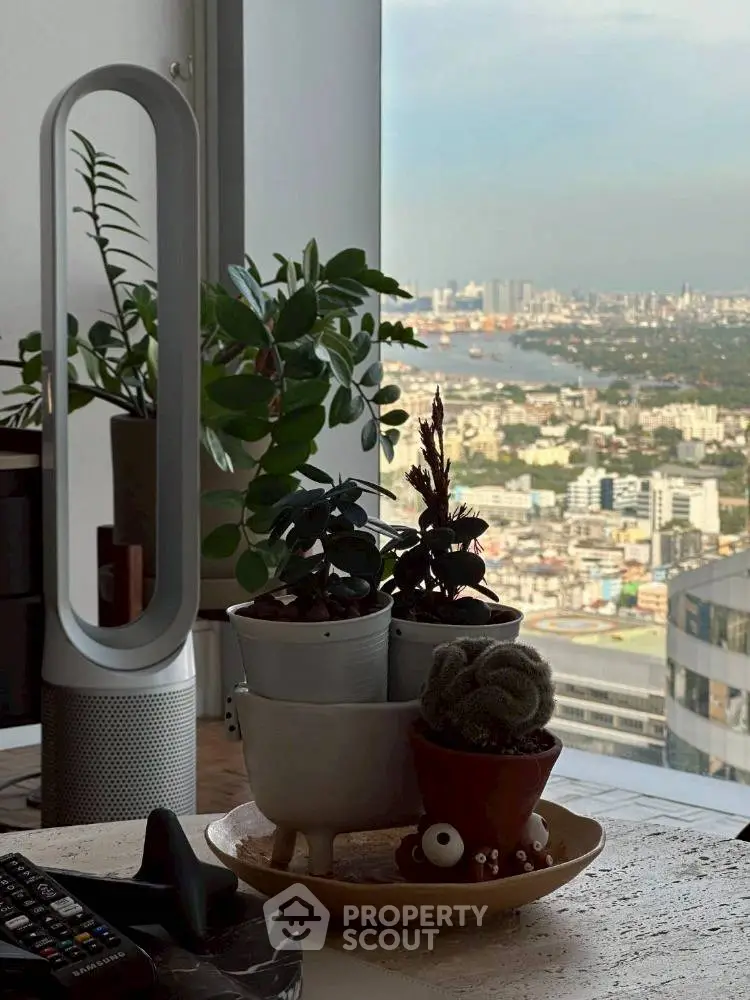 Modern living room with city view, stylish decor, and indoor plants.
