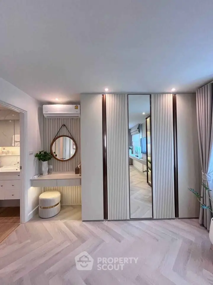 Stylish bedroom with mirrored wardrobe and elegant decor