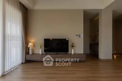 Spacious modern living room with sleek wooden flooring and elegant decor
