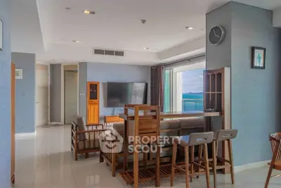Spacious living room with modern wooden furniture and stunning ocean view.