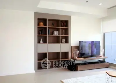Modern living room with built-in shelving and flat-screen TV, perfect for stylish urban living.