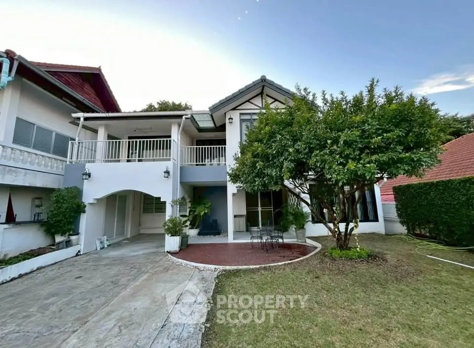 Charming two-story house with spacious garden and elegant balcony